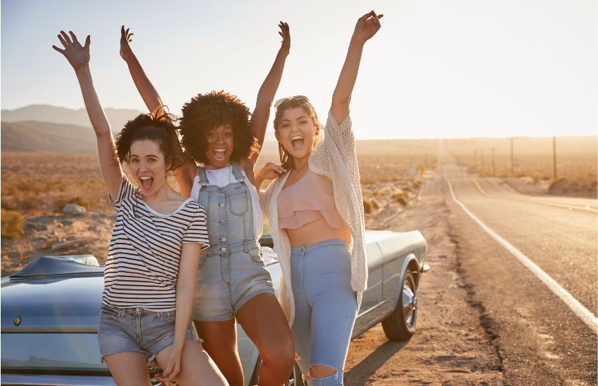 teenage girls posing for a photo on car trip